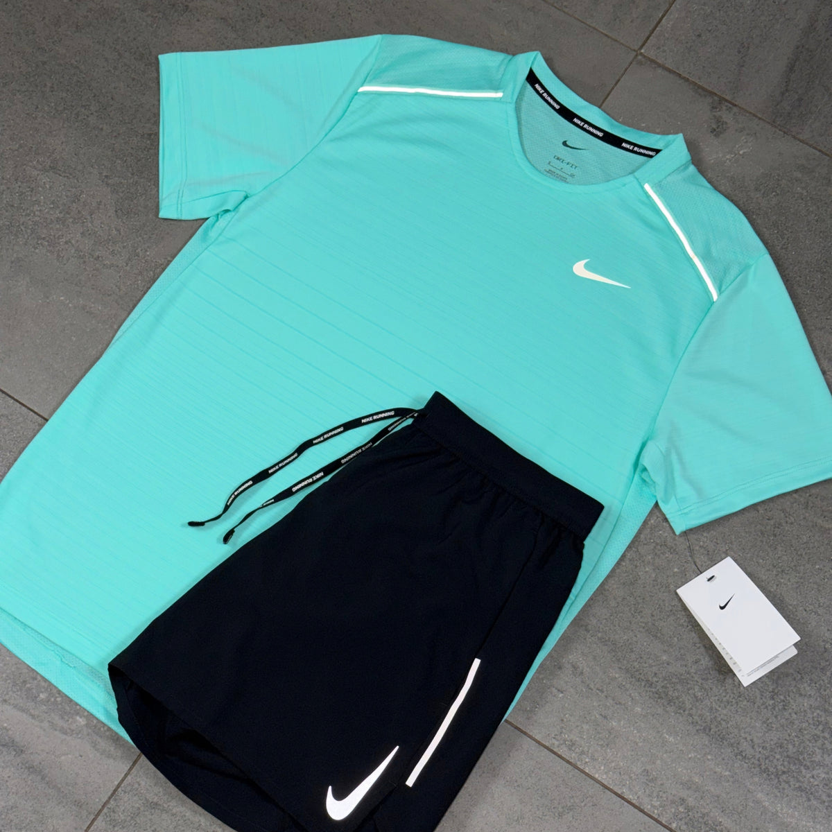 Hyper Turquoise Nike Miler running top displayed alongside black OG Flex shorts with white Swoosh branding
