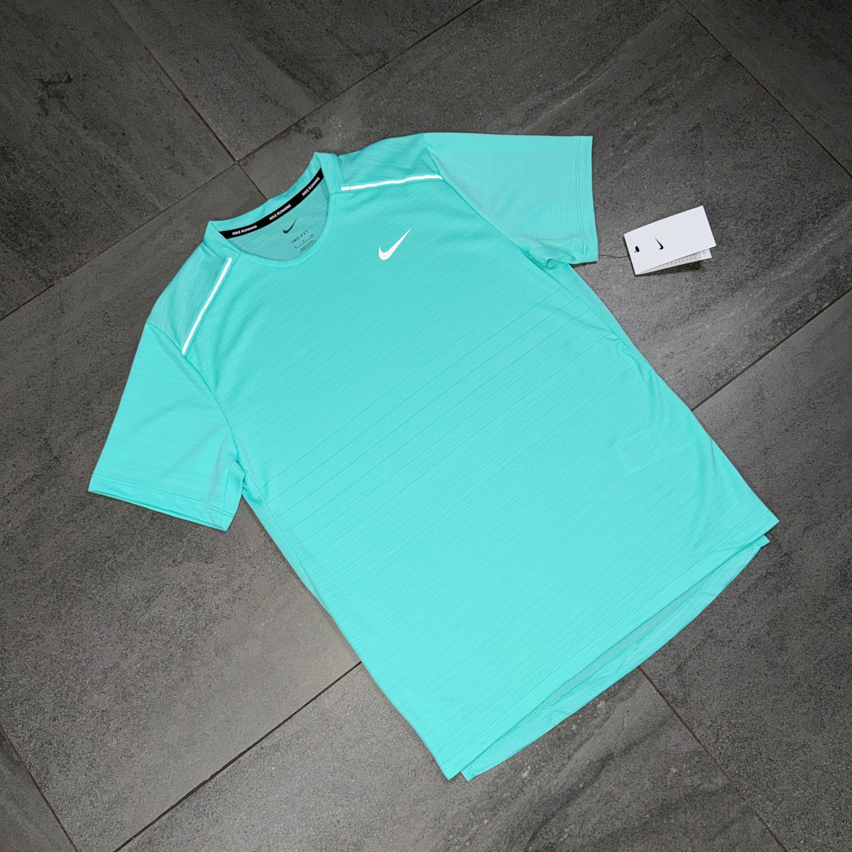Angled view of the Hyper Turquoise Nike Miler Dri-FIT performance top