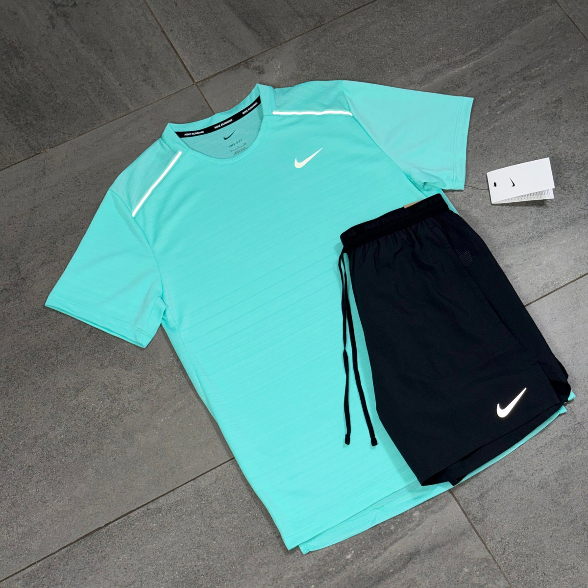 Hyper Turquoise Nike Miler T-Shirt with black Flex Stride running shorts displayed as a matching set