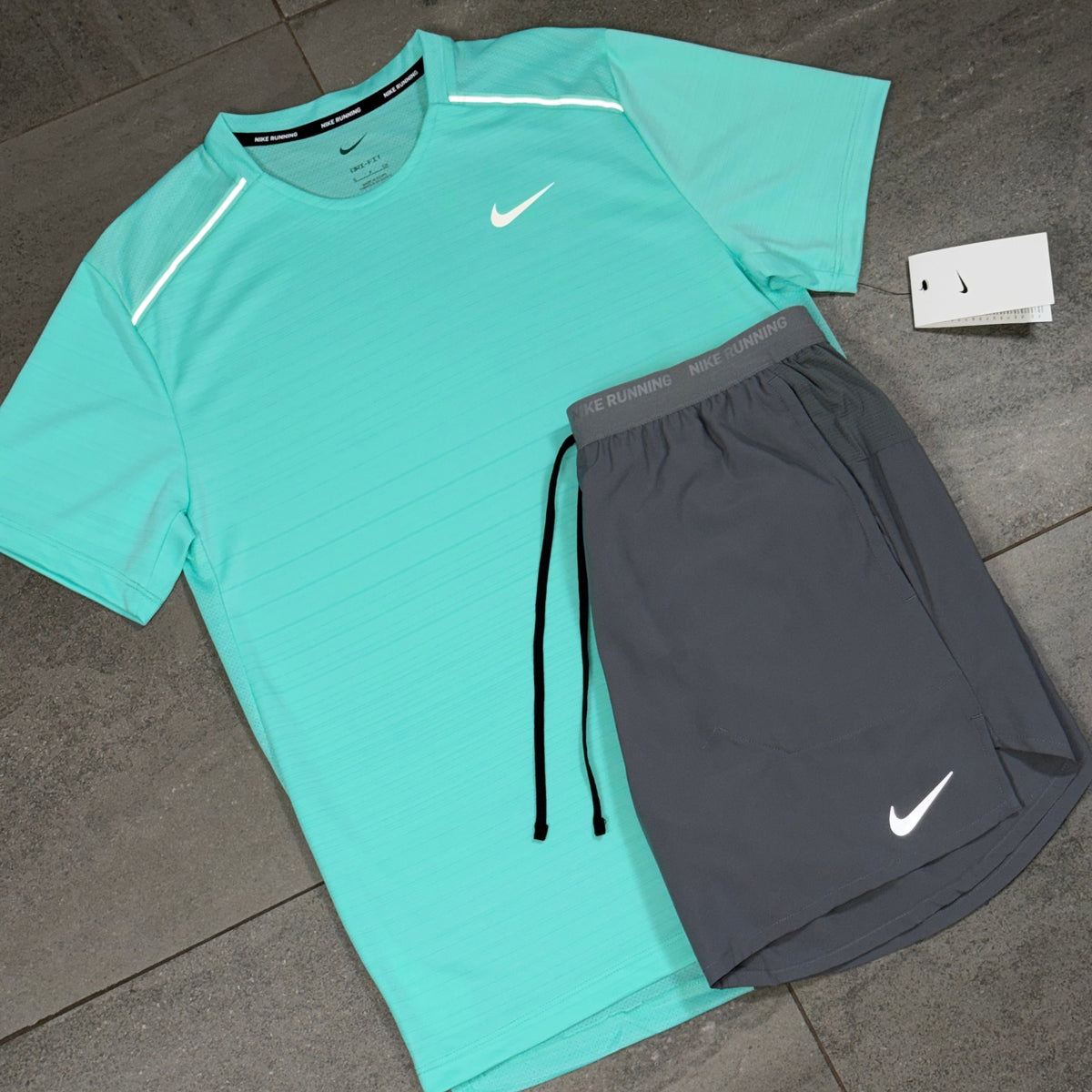 Men's Nike running kit featuring a bright Hyper Turquoise Miler top with contrasting grey shorts