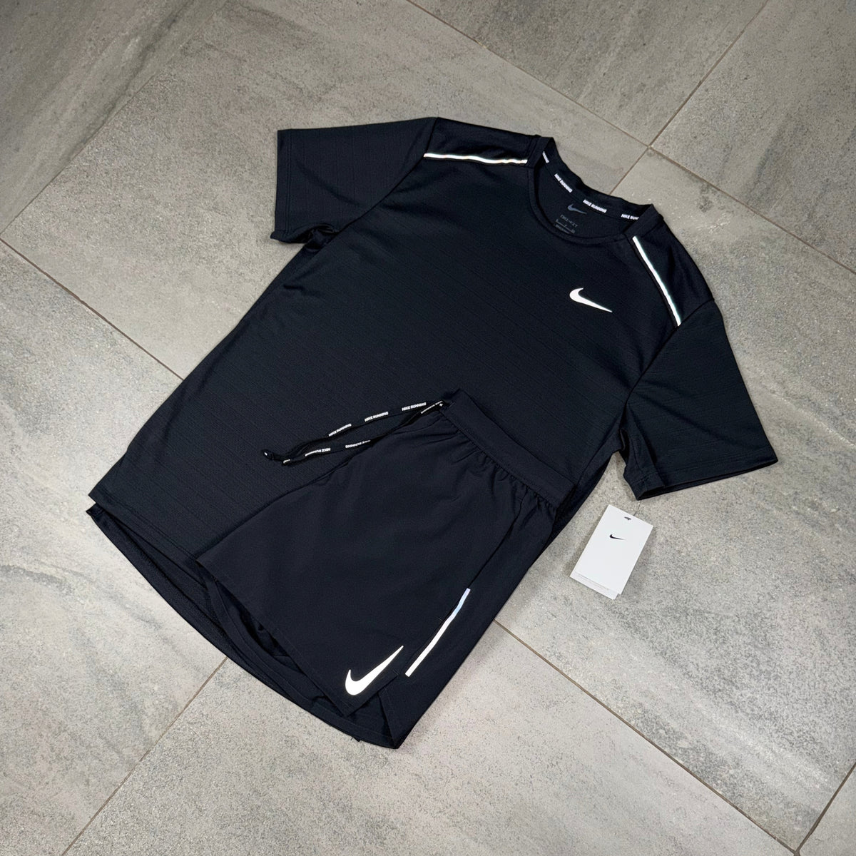 Close flat lay of the men's Nike Miler black top paired with black OG Flex shorts for training and gym wear