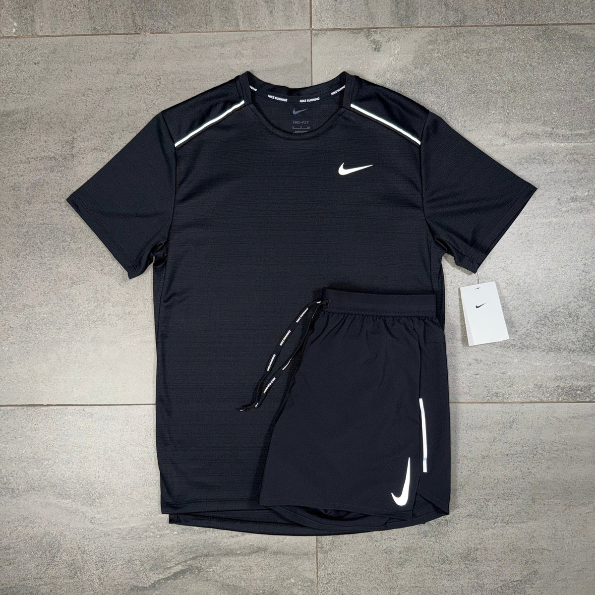 Nike Miler and OG Flex two-piece black sportswear set showing the T-shirt and branded shorts