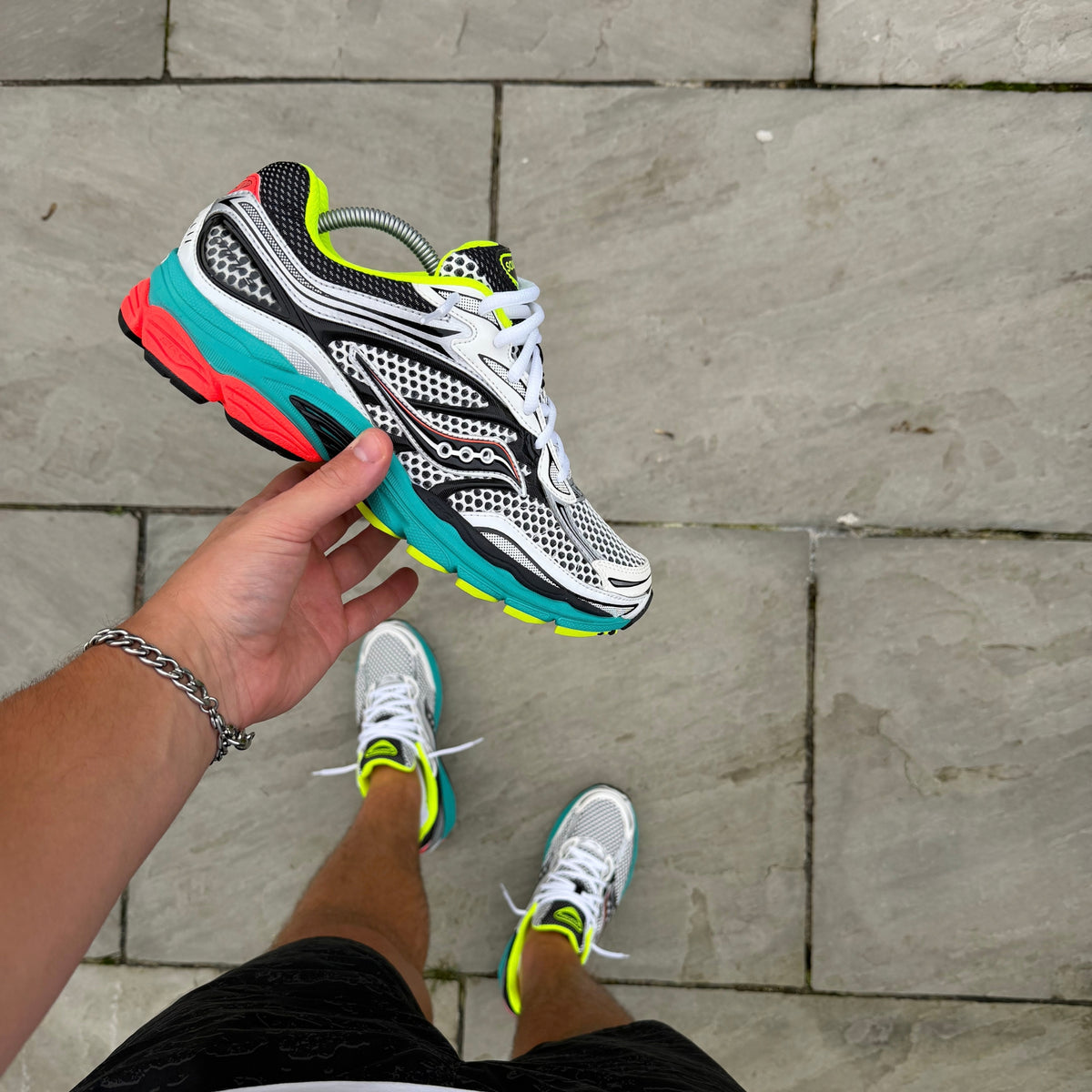Saucony ProGrid Omni 9 Silver Mutant trainers showing silver mesh, neon yellow, turquoise and red detailing