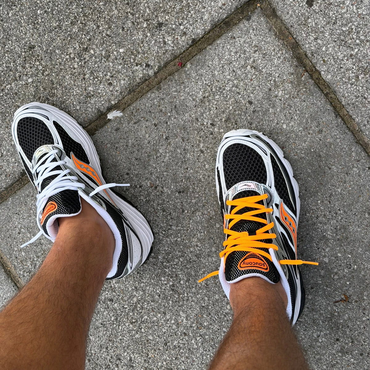 Saucony ProGrid Omni 9 White Orange trainers shown from above highlighting the white upper and bright orange laces